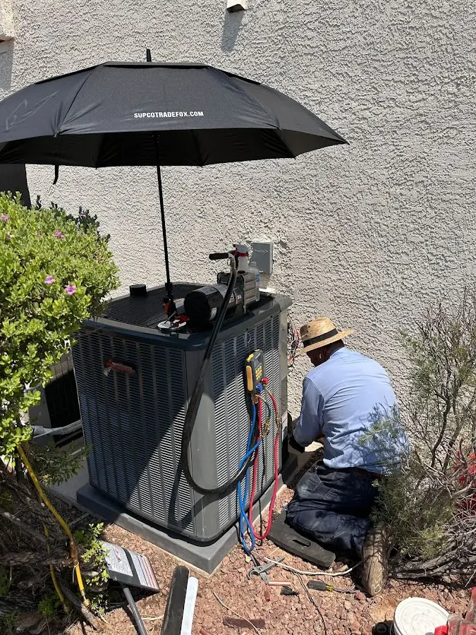 HVAC technician performing outdoor AC maintenance in Herndon